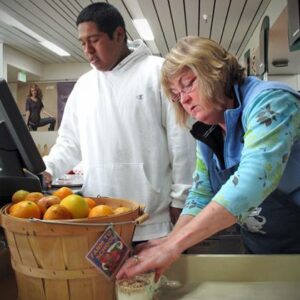 Harbor High School student Eric Lopez sells local produce in the student cafe