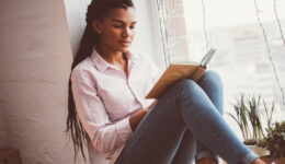 Concentrated African woman reading book