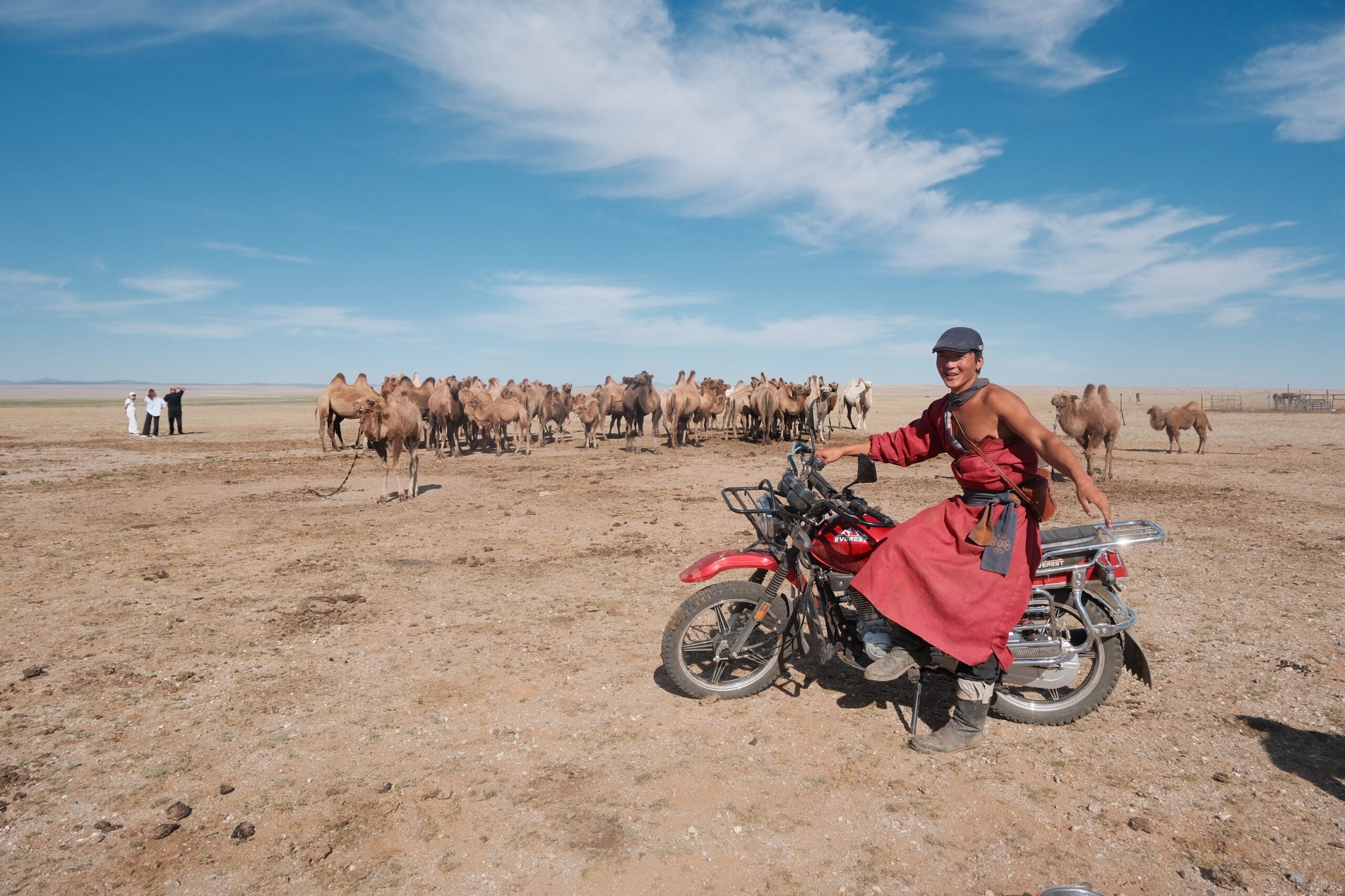 Shepherd herding camels on motorcyle, Govisümber 
Provence, Mongolia. Photo Credit: Melanie Marques